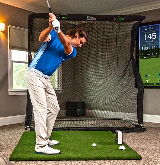 Man swinging with a SkyTrak Home Golf Simulator Package
