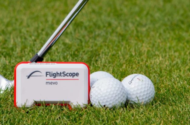 FlightScope Mevo Launch Monitor with balls and a club